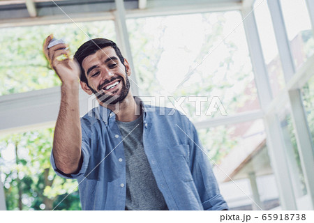 A man throwing a piece of paper while working at A man throwing a piece of paper while working at 65918738