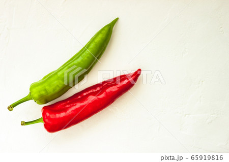 Red, green cayenne hot chili pepper on white background immune support healthy eating concept Red, green cayenne hot chili pepper on white background immune support healthy eating concept 65919816