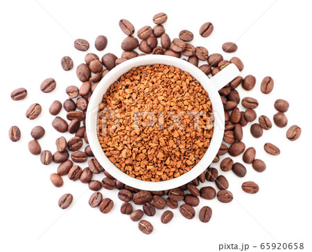 Instant coffee in a cup around coffee beans on a 65920658