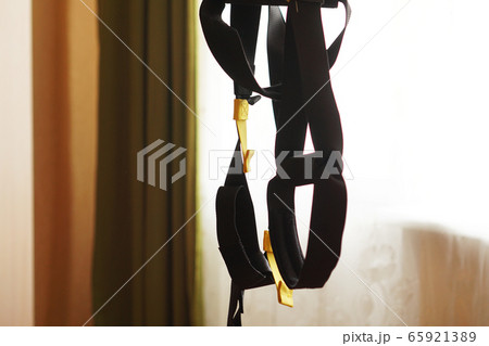 Closeup view of suspension training at home Closeup view of suspension training at home 65921389
