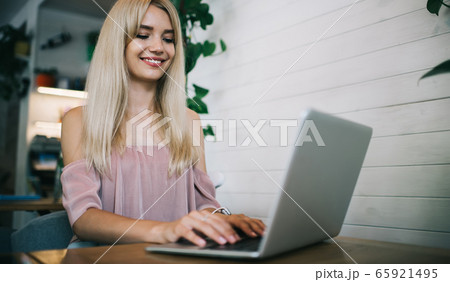 Happy woman working with laptop in cafe Happy woman working with laptop in cafe 65921495