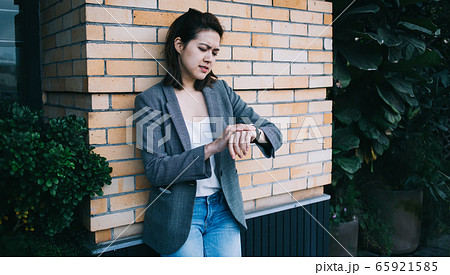 Pretty modern young female millennial in casual clothes 65921585