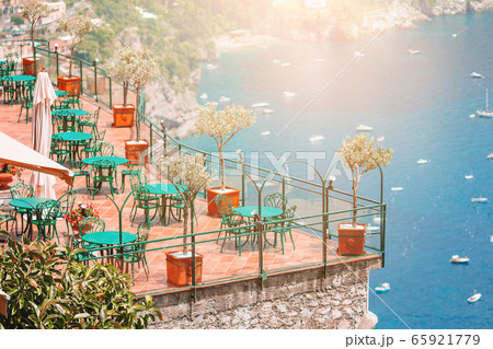 Summer empty outdoor cafe in a tourist place in Italy 65921779