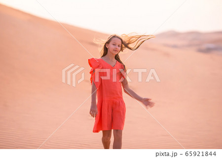 Girl among dunes in Rub al-Khali desert in United Arab Emirates 65921844