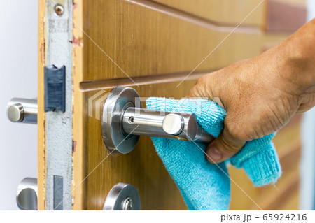 Prevention cleaning Door handles by Disinfectant solution for killing corona virus on touching surfaces, concept coronavirus COVID19. 65924216