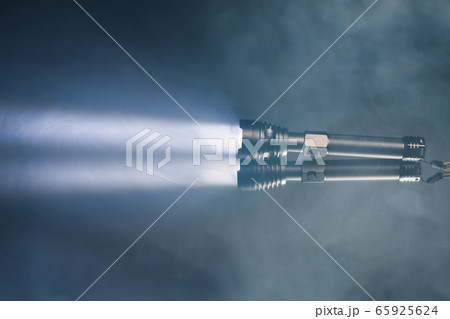 ray of pocket flashlight in smoke, copy-space ray of pocket flashlight in smoke, copy-space 65925624