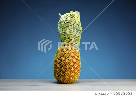 pineapple packed in transporting mesh, blue pineapple packed in transporting mesh, blue 65925652