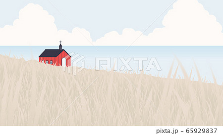Red church located on seashore and small hill 65929837
