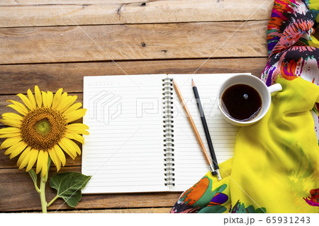 notebook planner for business work with hot coffee, yellow flowers sunflower ,scarf arrangement flat lay style 65931243