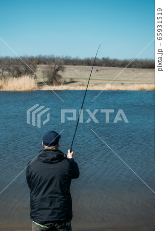 Feeder fishing. Male fisherman fishing at sun day 65931519