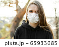 Close up of woman wearing protective face mask outdoor. Coronavirus covid-19 outbreak prevention concept. 65933685