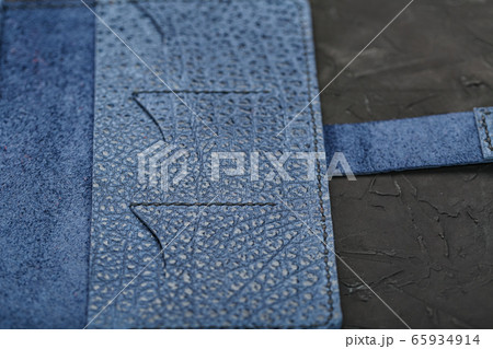 Blue leather wallet on a black textured 65934914