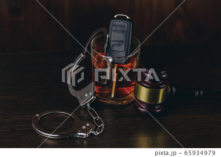Whiskey with car keys and handcuffs. Concept for drinking and driving 65934979