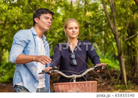 Young couple in love and going for a bike ride on 65935540