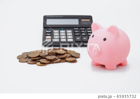 Pink piggy or coin bank or piggybank or money box, coins and calculator - finance and savings concept on white background 65935732