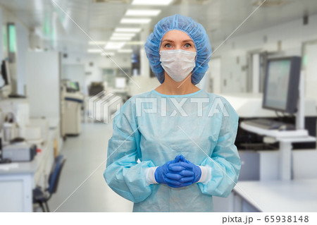 Portrait of doctor in scrubs. A female doctor in a protective face mask in safety measures against the coronavirus. 65938148