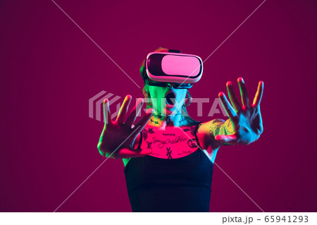 Portrait of young caucasian woman on purple background with copyspace, unusual and freaky appearance 65941293