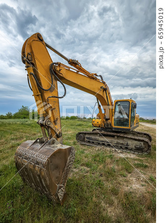 A parked yellow excavator A parked yellow excavator 65945019
