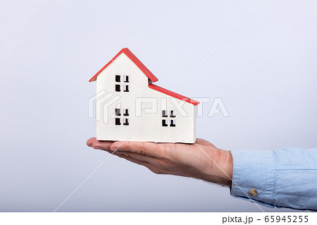 Model of house on palm on white background. Buy 65945255