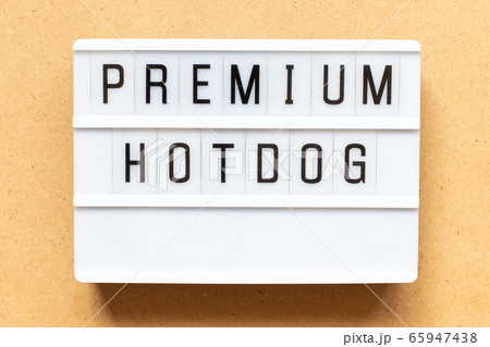 Lightbox with word premium hotdog on wood background Lightbox with word premium hotdog on wood background 65947438