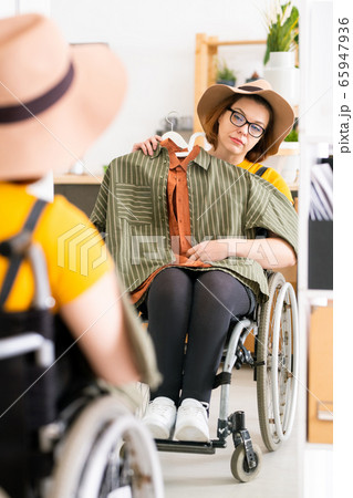 Choosing outfit in front of mirror 65947936