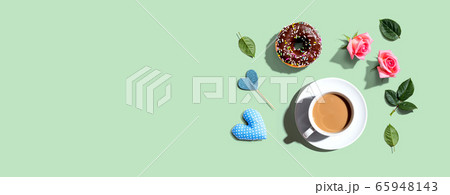 A cup of coffee with pink roses 65948143