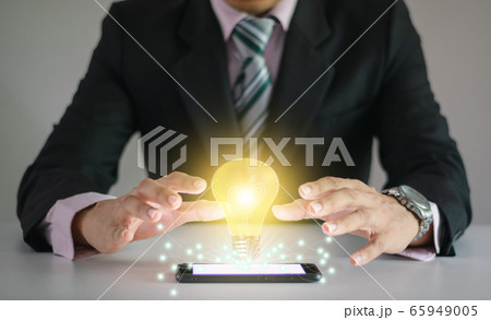 Light bulb new ideas with innovative technology solution concepts hands of the businessman. Light bulb new ideas with innovative technology solution concepts hands of the businessman. 65949005