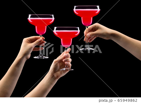 Set of hands holding strawberry margarita glass 65949862
