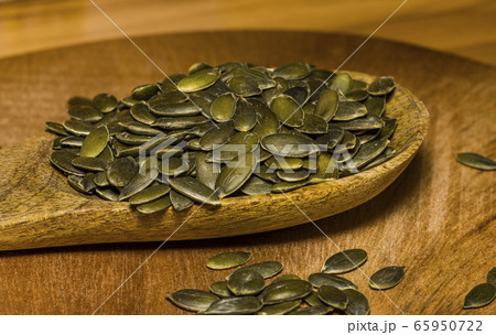 Pumpkin seeds in a pile wide angle macro sliding 65950722