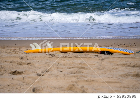 surf board by the sea on the sand 65950899