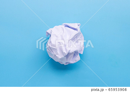 Crumpled paper ball on blue background. 65953908