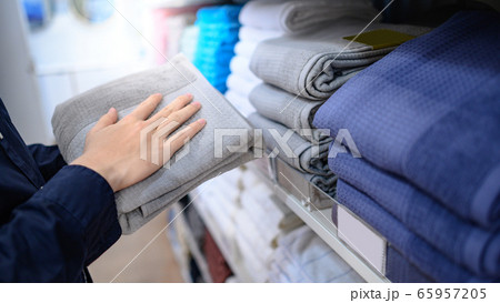 Male hand choosing gray towel in cloth shop 65957205
