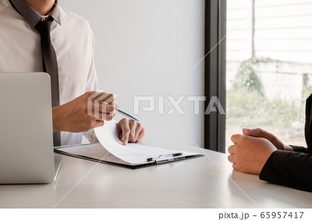 Business people hold a job profile and talk to job applicants for job interviews about careers and business concepts Business people hold a job profile and talk to job applicants for job interviews about careers and business concepts 65957417