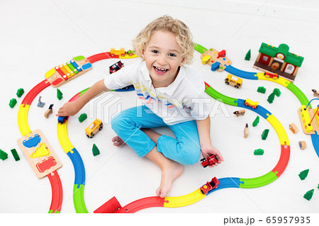 Child with toy train. Kids wooden railway. 65957935