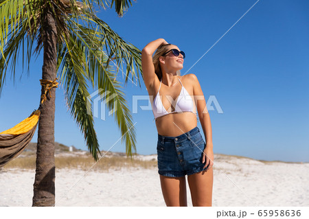 Caucasian woman enjoying time at the beach Caucasian woman enjoying time at the beach 65958636