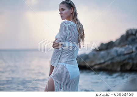fit woman in posing on beach. Stylish look woman fit woman in posing on beach. Stylish look woman 65963459