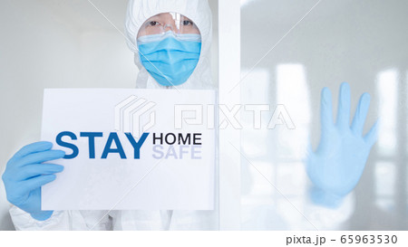 Doctor showing paper stay home stay safe 65963530