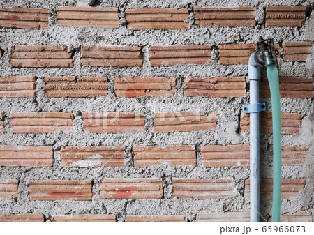 Faucet on brick wall with copy space 65966073
