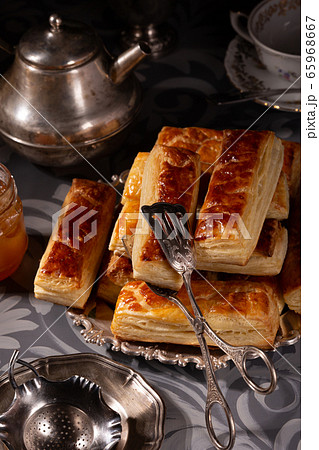 Puff pastry cookies in vintage utensils on a gray Puff pastry cookies in vintage utensils on a gray 65968667