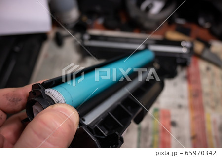 the master holds the disassembled laser printer cartridge 65970342