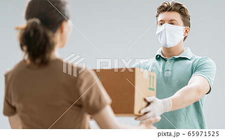 Woman accepting boxes from courier. 65971525