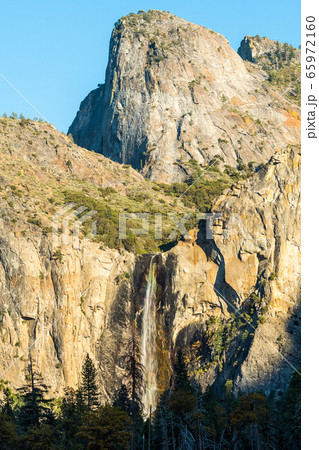 Sunset view of the bridalveil waterfall and Cathedral peak at the bottom of the Yosemite Valley 65972160