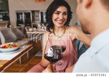 Beautiful lady spending time with gentleman in restaurant Beautiful lady spending time with gentleman in restaurant 65973381