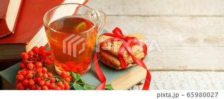 Autumn, fall leaves, cup of tea, opened book on 65980027
