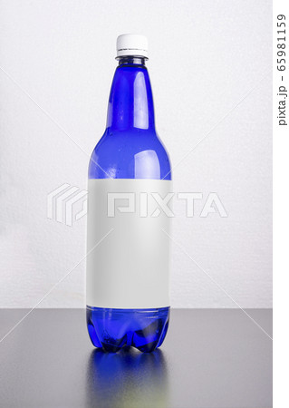 Blue bottle with label on table surface mock-up 65981159