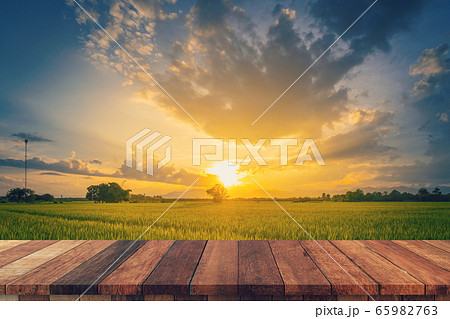 Rice field sunset and Empty wood table for product Rice field sunset and Empty wood table for product 65982763