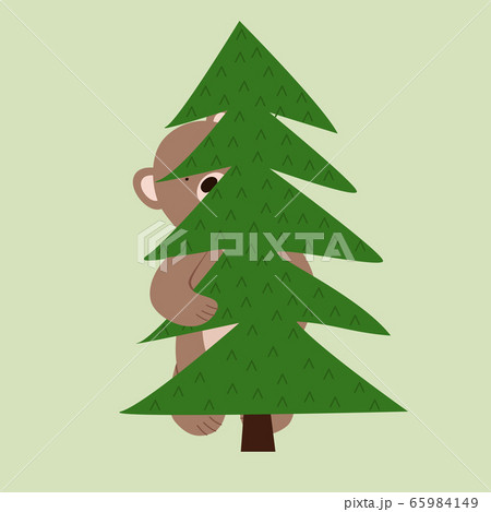 Funny little bear cub hiding peeks out from behind the tree. 65984149