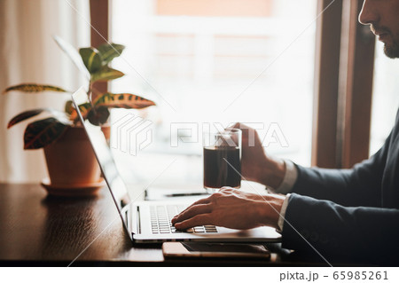 office worker typing on keyboard of laptop in office worker typing on keyboard of laptop in 65985261
