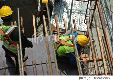 Construction workers fabricating timber form work mostly using timber and plywood at the construction site in Perak, Malaysia.   65985905