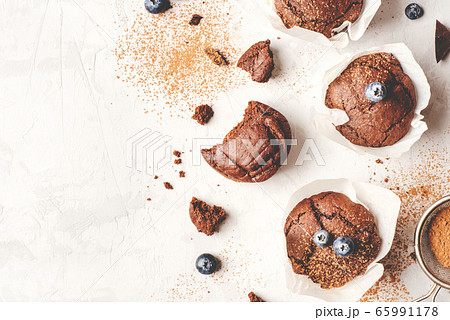 Homemade fresh chocolate muffins with berries and chocolate pieces. Homemade fresh chocolate muffins with berries and chocolate pieces. 65991178